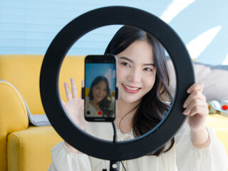 Close up mobile phone digital camera asian young beautiful happy funny woman smile live broadcast sharing on social network at home influencer vlogger blogger recording video media marketing online.