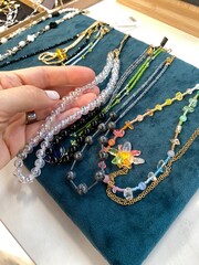Glass bead necklaces displayed on teal velvet background showcasing handcrafted jewelry design
