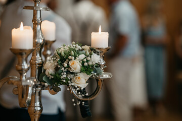 Romantic white rose bouquet and candles arranged for a wedding celebration