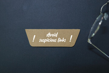 colored paper with the words Avoid suspicious links. relates back to the dangers of a potential...