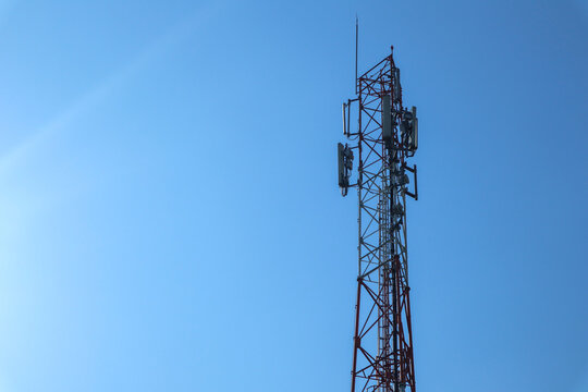 " communication tower. Telco Trellis for 3G 4G 5G Apocalypse Internet Communication, mobile, FM Radio and Television Broadcasting On Air with Blue Sky in Background"