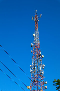 " communication tower. Telco Trellis for 3G 4G 5G Apocalypse Internet Communication, mobile, FM Radio and Television Broadcasting On Air with Blue Sky in Background"