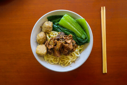 mie ayam or noodles chicken is traditional food from indonesia, asia made from noodle, chicken, chicken broth, spinach, sometimes with meatball.