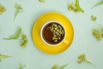 ime tea in a yellow cup with lime flowers