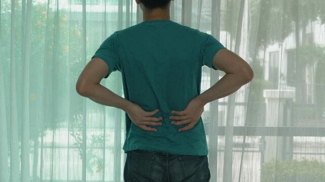 closeup massaging back suffering from acute back pain arthritis backache acute muscle injury