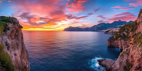 Dramatic coastal sunset over rocky cliffs