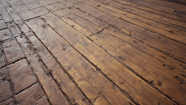 A wooden floor with a noticeable brown stain