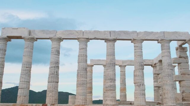 Temple of Poseidon on Cape Sounion at sunset, Attica, Greece. Ancient Greek architecture. Ruins of ancient temple of Greek god of the sea with marble columns. Popular travel and touristic destination