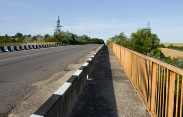 A road with a fence and trees
