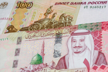 100 Russian ruble and 100 Saudi riyal banknotes. International trade concept
