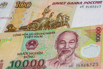 100 Russian ruble and 10000 Vietnamese dong banknotes. International trade concept