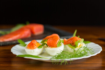 Tender appetizer with salmon, eggs and dill