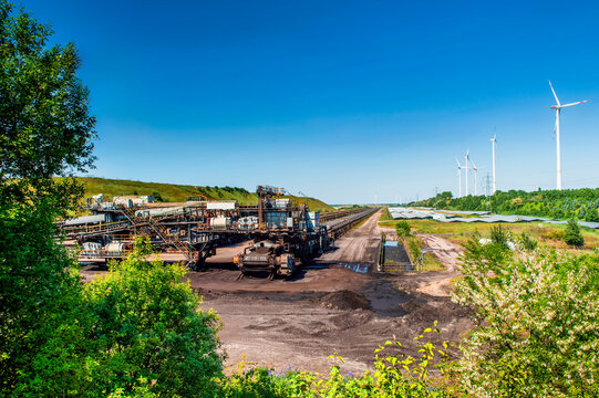 Garzweiler opencast mine with conveyor belts, wind turbines, and solar plant on public land