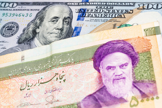 100 US dollar and 50000 Iranian rial banknotes. International trade concept