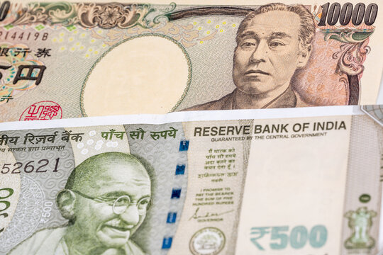 10000 Japanese yen and 500 Indian rupee banknotes. International trade concept