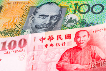 100 Australian dollar and 100 New Taiwan dollar banknotes. International trade concept