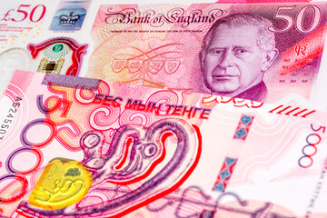 50 British pound and 5000 Kazakhstani tenge banknotes. International trade concept