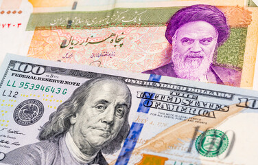 50000 Iranian rial and 100 US dollar banknotes. International trade concept