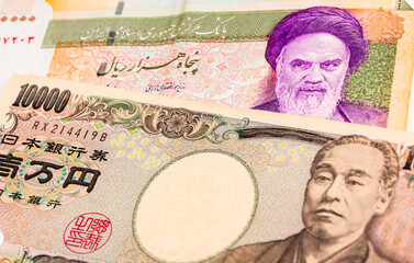 50000 Iranian rial and 10000 Japanese yen banknotes. International trade concept