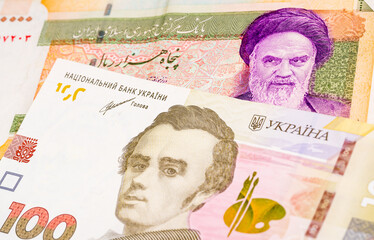 50000 Iranian rial and 100 Ukrainian hryvnia banknotes. International trade concept