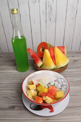 fresh fruits and a bottle of syrup