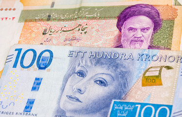 50000 Iranian rial and 100 Swedish krone banknotes. International trade concept