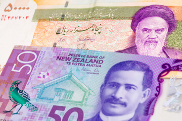 50000 Iranian rial and 50 New Zealand dollar banknotes. International trade concept