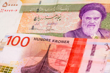 50000 Iranian rial and 100 Norwegian krone banknotes. International trade concept