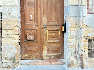 A crumbling inner city building gate.