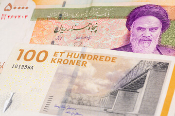 50000 Iranian rial and Danish krone banknotes. International trade concept