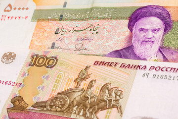 50000 Iranian rial and 100 Russian ruble banknotes. International trade concept