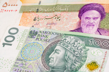50000 Iranian rial and 100 Polish zloty banknotes. International trade concept