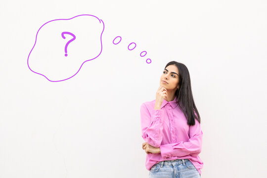 Woman in pink shirt standing against white wall with question illustration
