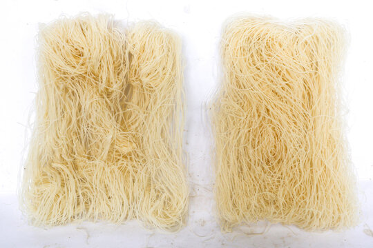 raw dry bihun or vermicelli or rice noodles or angel hair isolated on white background