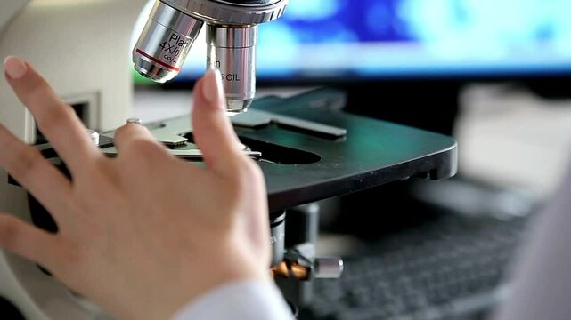 In the laboratory, a scientist uses an electron microscope to examine the details of viruses, which contributes to research in the field of virology.