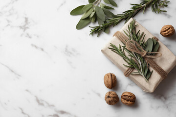 Autumn Blank Card Flat Lay with Kraft Wrapped Gift, Pine Needles, Walnuts, spices and herbs on wooden table