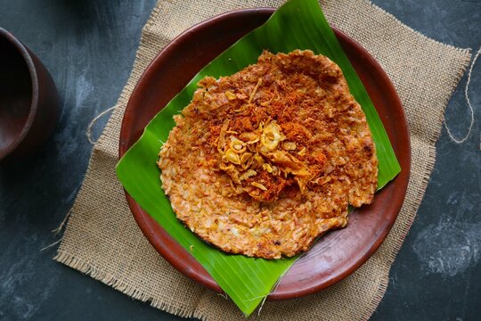 kerak telor or Egg Crust. kerak telor is Spicy Glutinous Rice Omelette with Grated Coconut. made from glutinous rice cooked, egg, serundeng, fried shallots and dried shrimp topping.