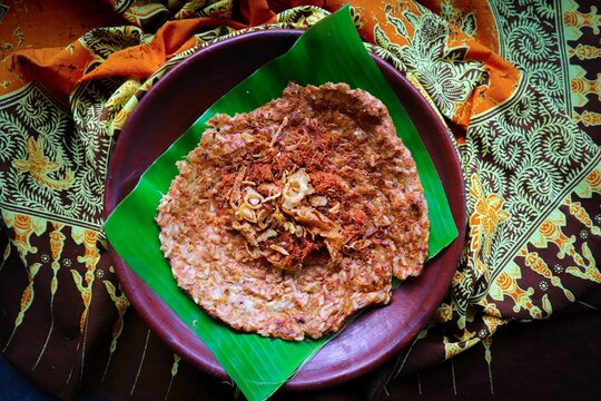 kerak telor or Egg Crust. kerak telor is Spicy Glutinous Rice Omelette with Grated Coconut. made from glutinous rice cooked, egg, serundeng, fried shallots and dried shrimp topping.