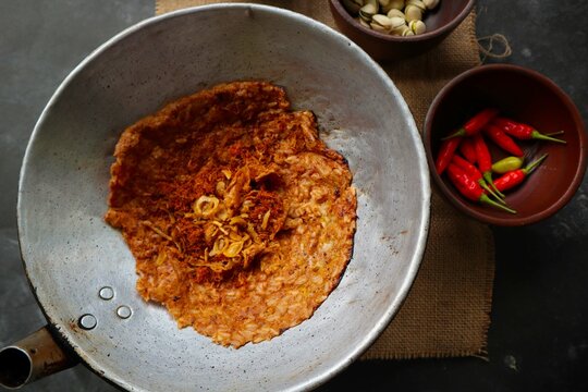 kerak telor or Egg Crust. kerak telor is Spicy Glutinous Rice Omelette with Grated Coconut. made from glutinous rice cooked, egg, serundeng, fried shallots and dried shrimp topping.