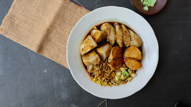 Pempek or empek-empek or fish cake is a food made from soft ground fish meat mixed with tapioca flour or sago flour, eggs, mashed garlic, flavoring, and salt
