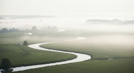 Fototapeta premium A serene landscape with a winding river, lush green fields, and misty atmosphere, evoking a sense of tranquility and natural beauty.