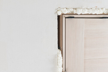 apartment renovation, close-up of door frame installation, removal of mounting foam