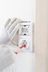 installation of a light switch socket after renovation on a white wall