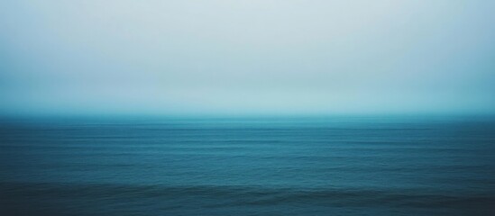 Obraz premium Serene Ocean Vista: A Misty Seascape