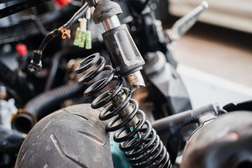 motorcycle rear shock absorbers is broken, damaged rear shock. motorcycle repair concept