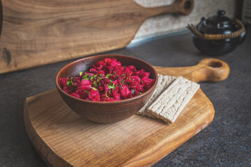 Top view of traditional vegetable salad with beetroot and parsley. Served with crispbread on a...