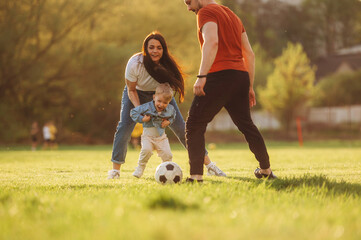 Soccer game. Family of mother, father and son are playing on the field