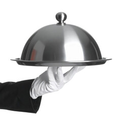 Fototapeta premium A hand in a white glove holds a polished silver serving tray with a dome cover, typical of formal dining service.