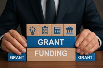 Wooden blocks arranged to display the concept of grant funding.