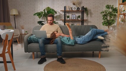 Obraz premium Cozy Couple Relaxing in Modern Living Room on Comfortable Sofa